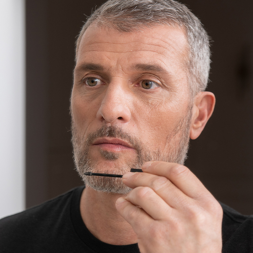 model-shows-how-to-use-be-bushy-brow-mascara-transparent-on-beard-by-brushing-it