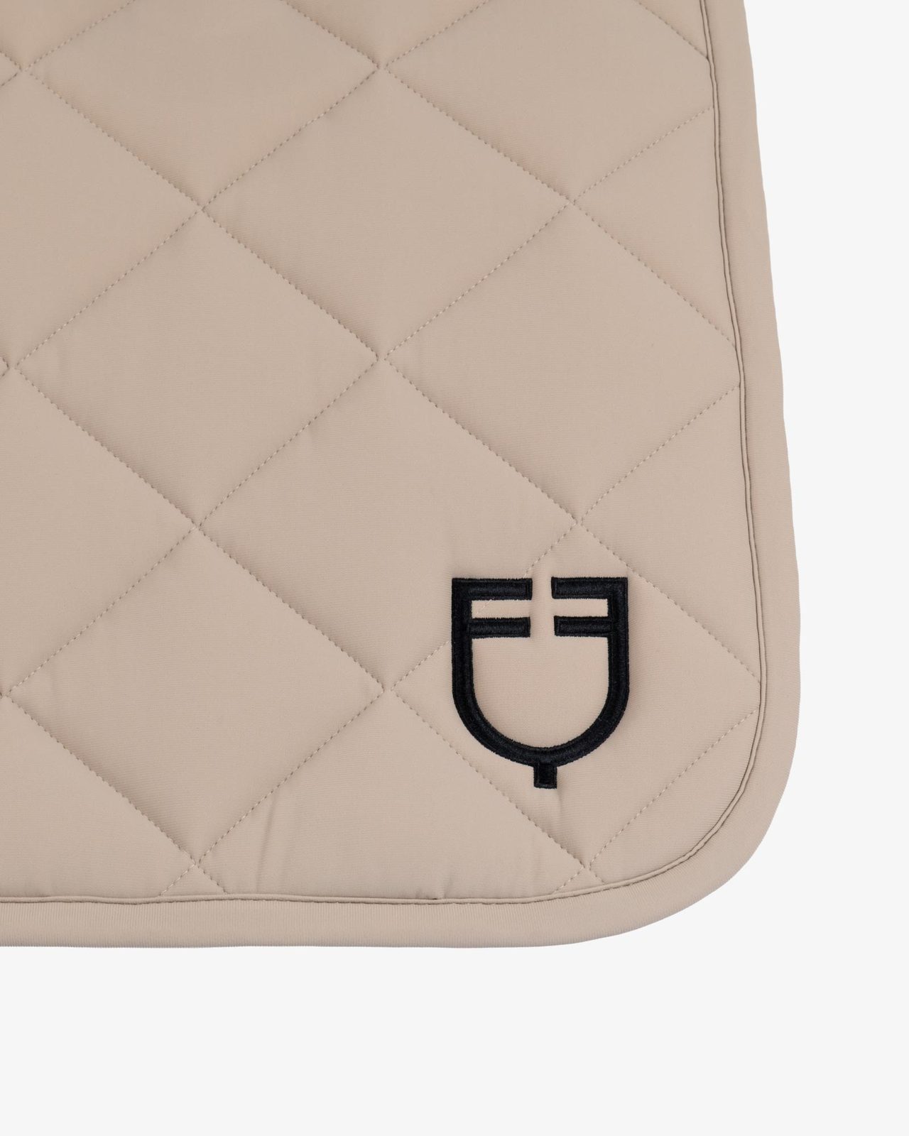 Dressage saddle pad with diamond quilting and embroidered logo